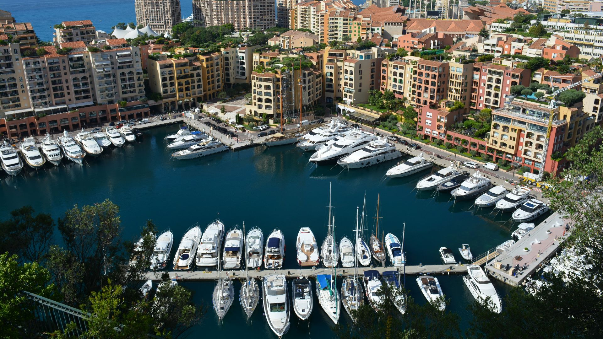 white boat on water near city buildings during daytime