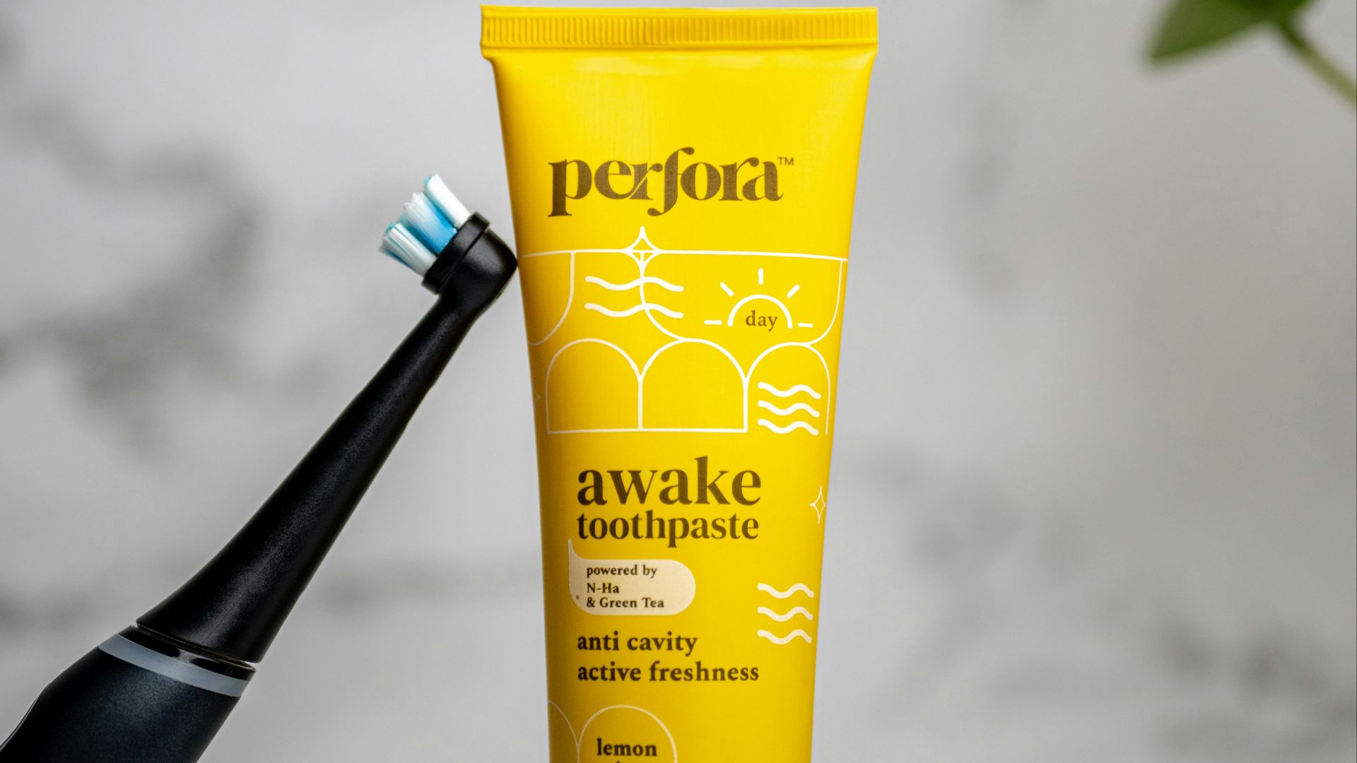 a toothbrush and tube of toothpaste sitting on a stand