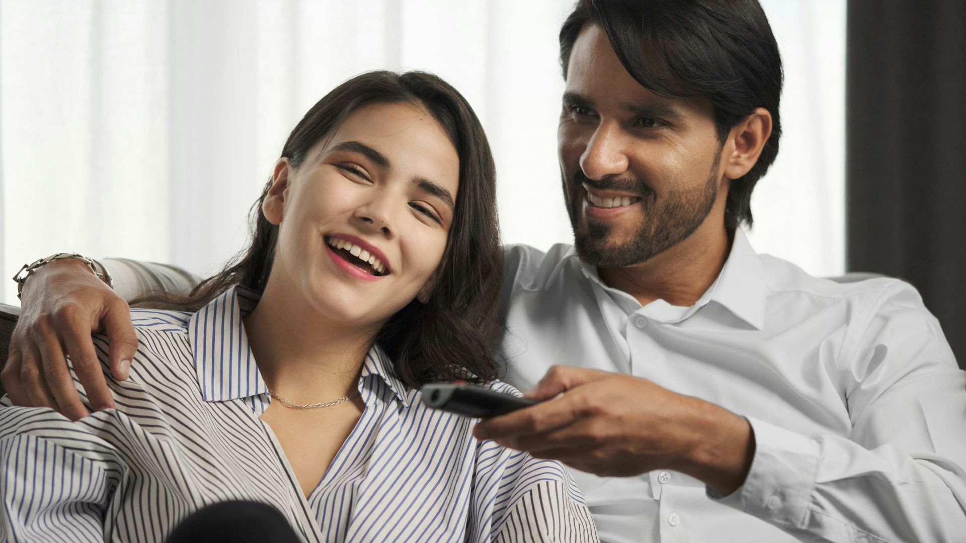 a man sitting next to a woman on a couch