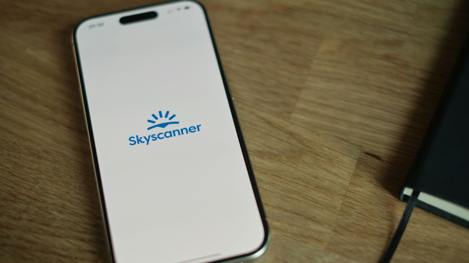 A cell phone sitting on top of a wooden table