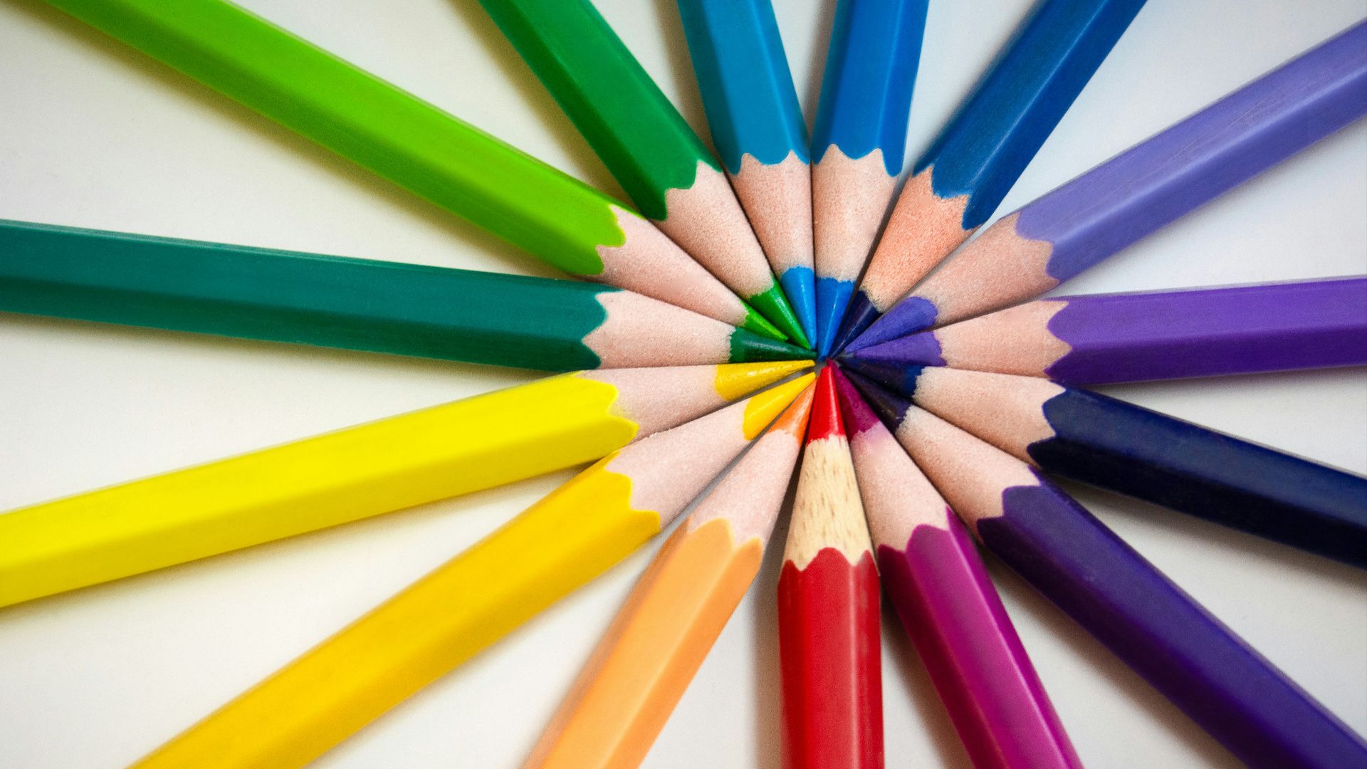 multi colored pencils on white surface