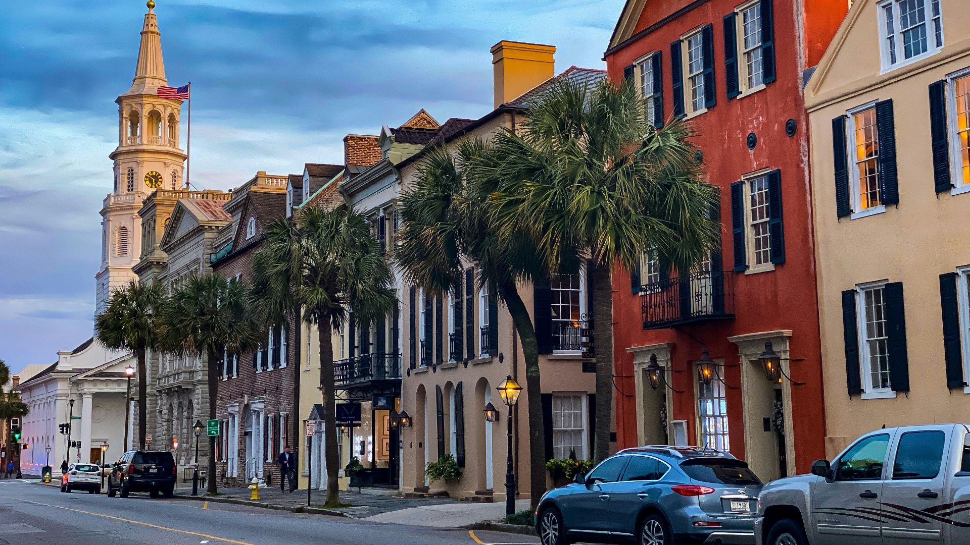 cars parked beside brown concrete building during daytime