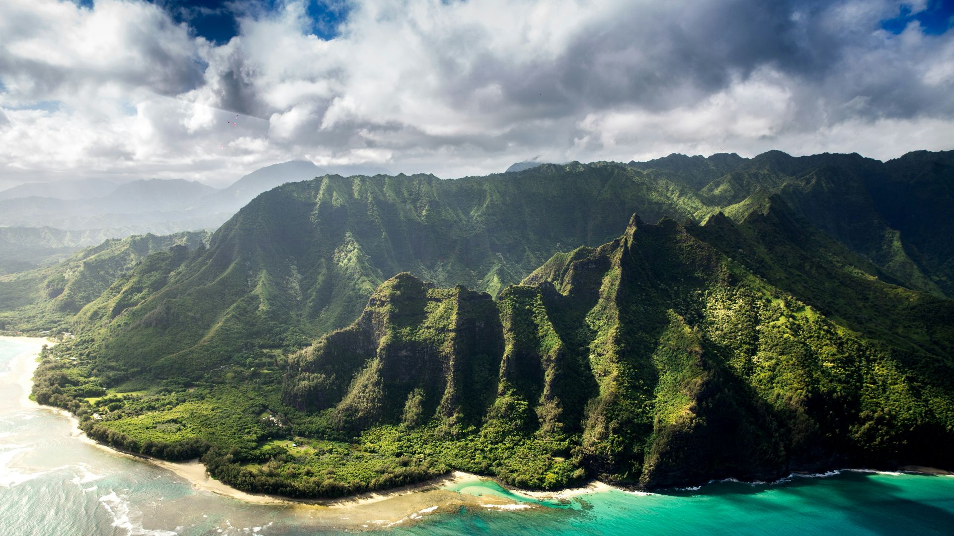 aerial photography of green mountain beside body of water under white sky