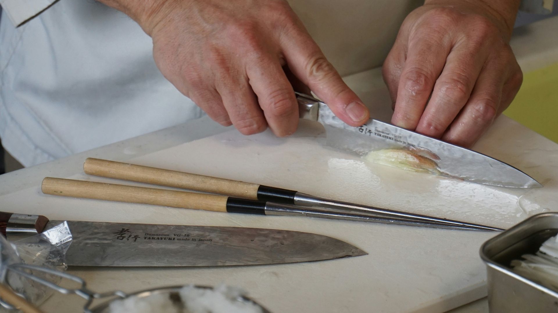 person in white button up shirt holding silver knife