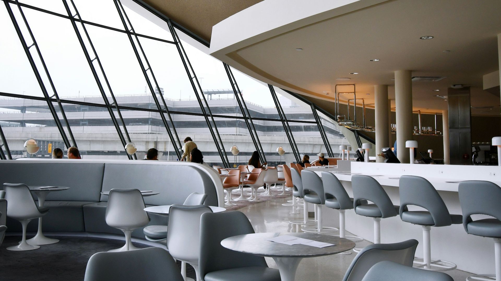 people sitting on white chairs inside building