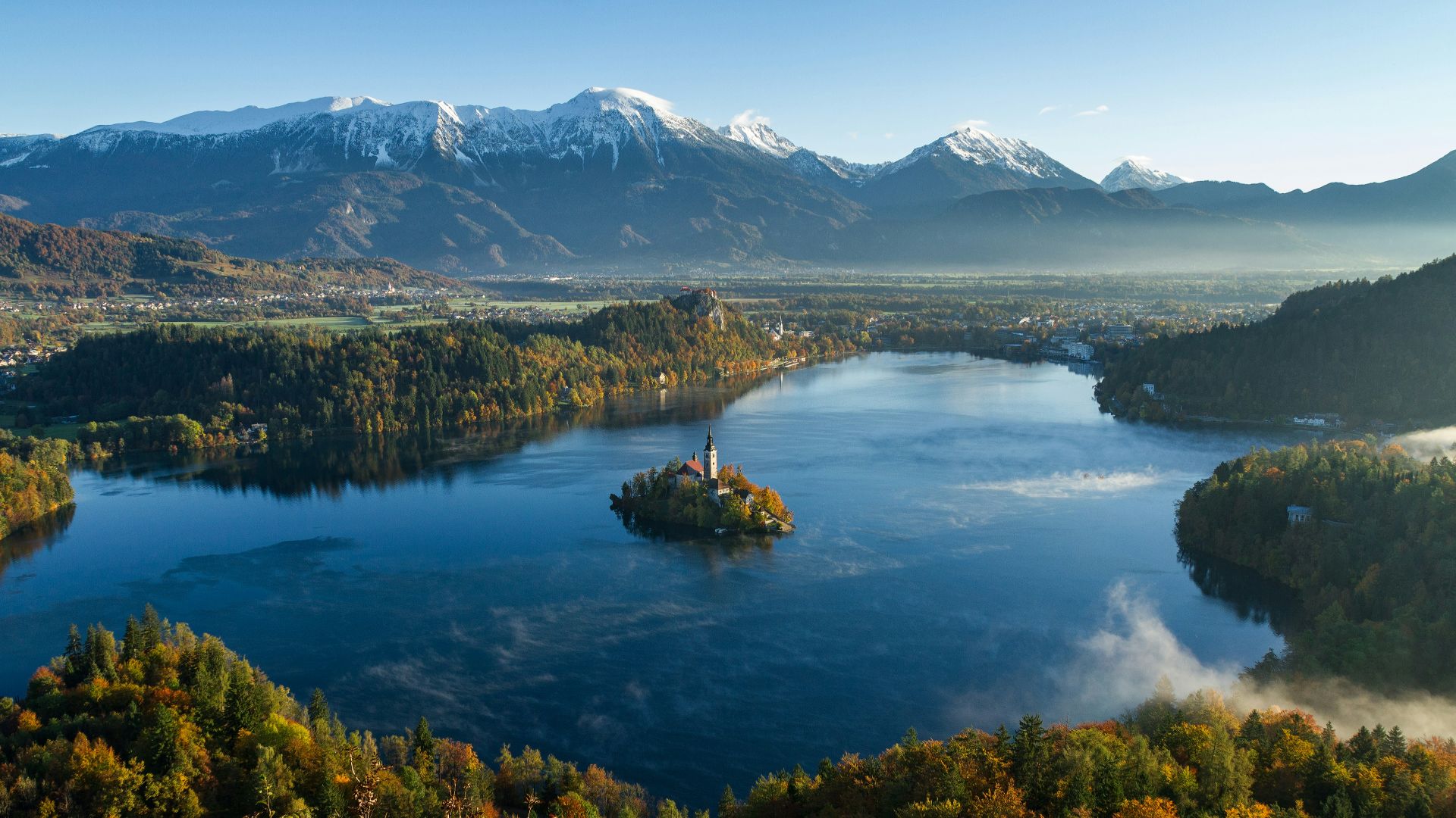 island surrounded by water and mountains at daytime