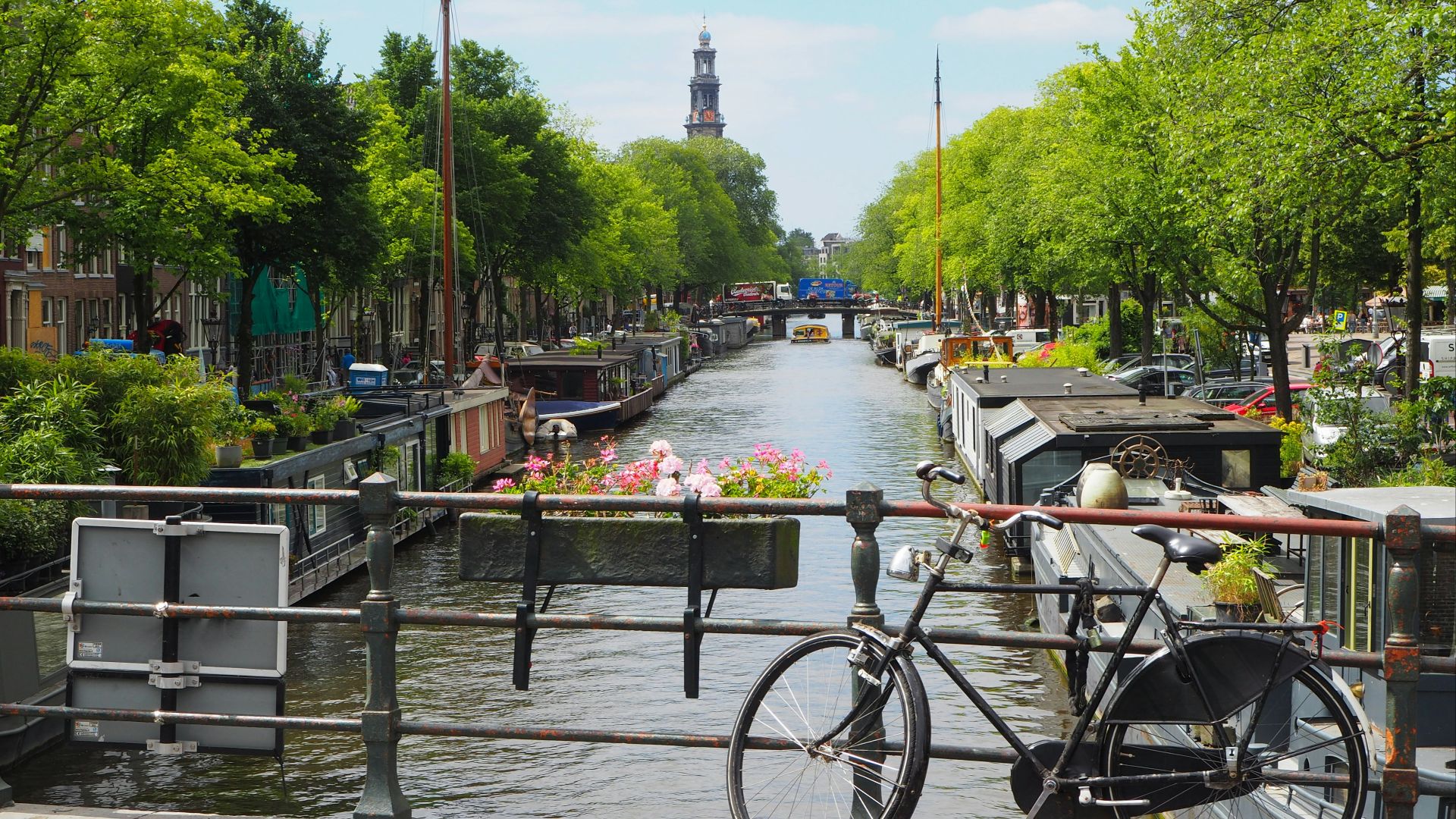 black city bike parked beside river during daytime
