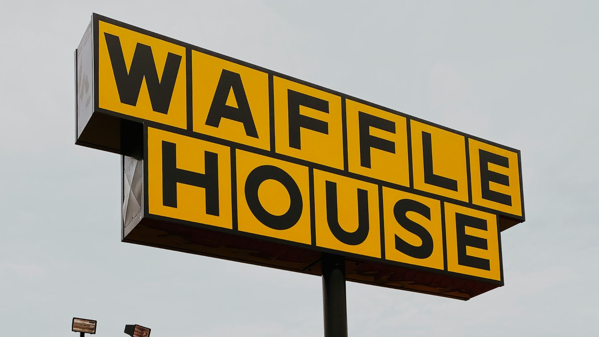 man and woman walking towards Waffle House store
