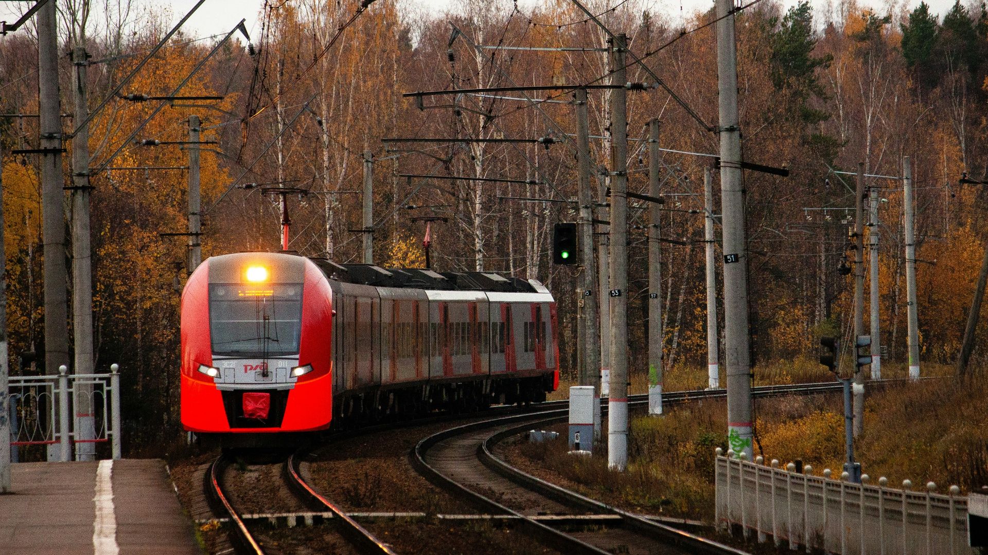 orange train on railroad during daytime
