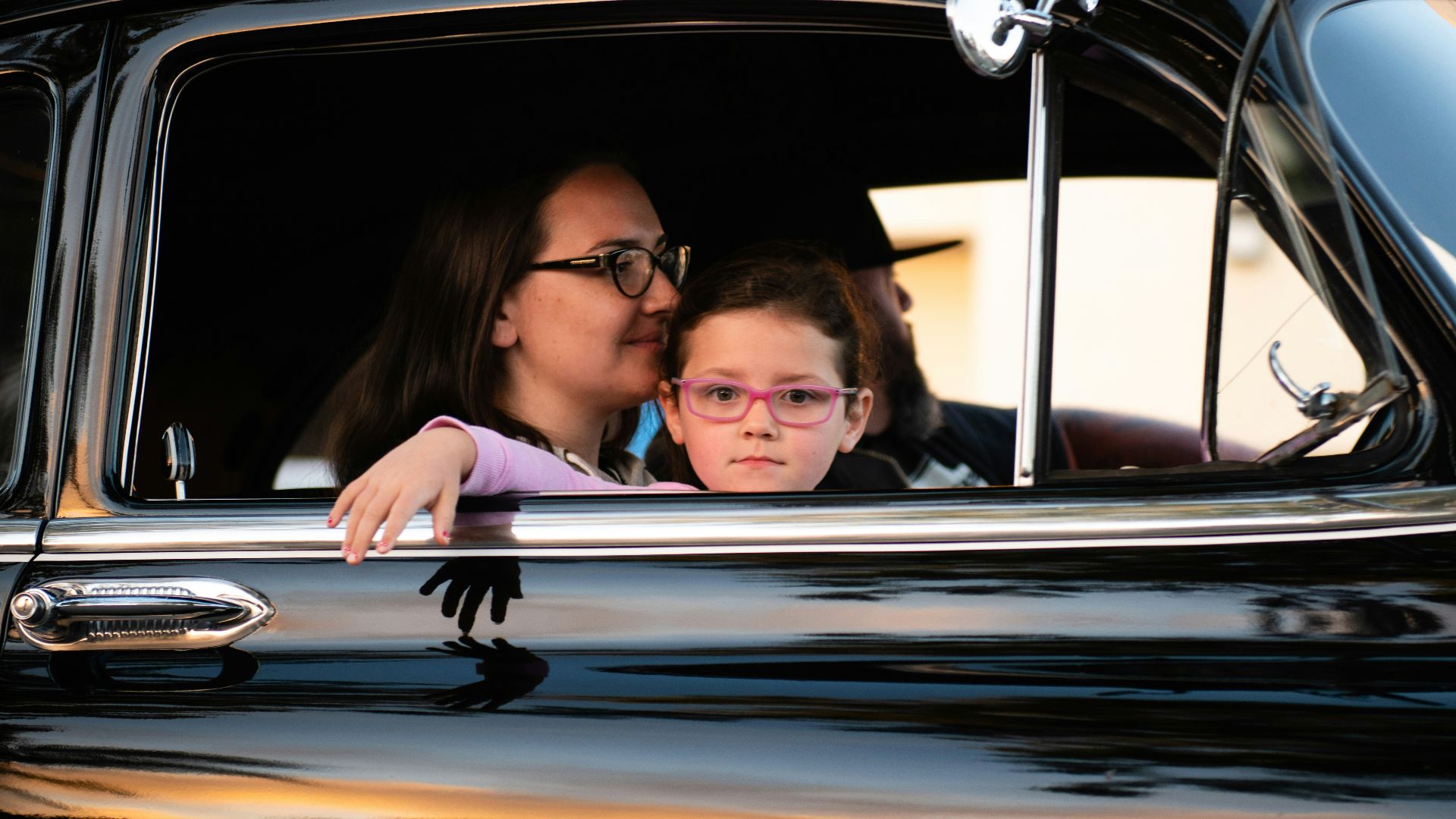 girl and woman inside black car