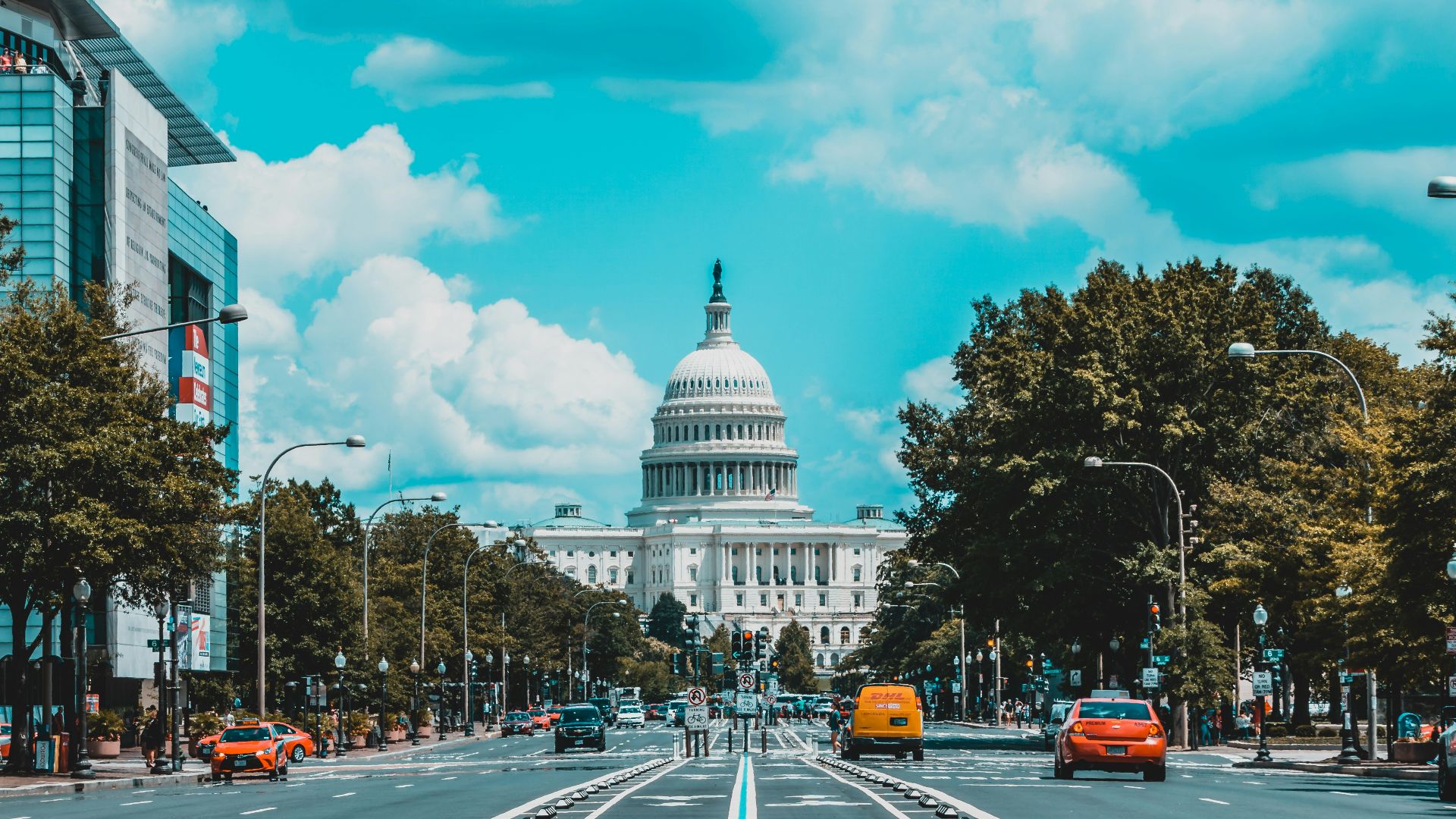 wide road with vehicle traveling with white dome building