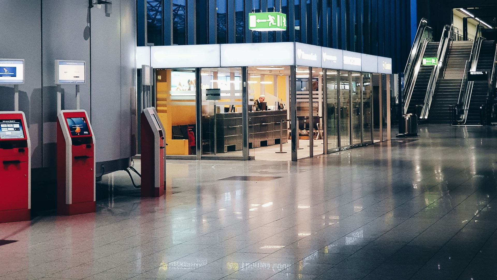 red and white digital machine near escalator