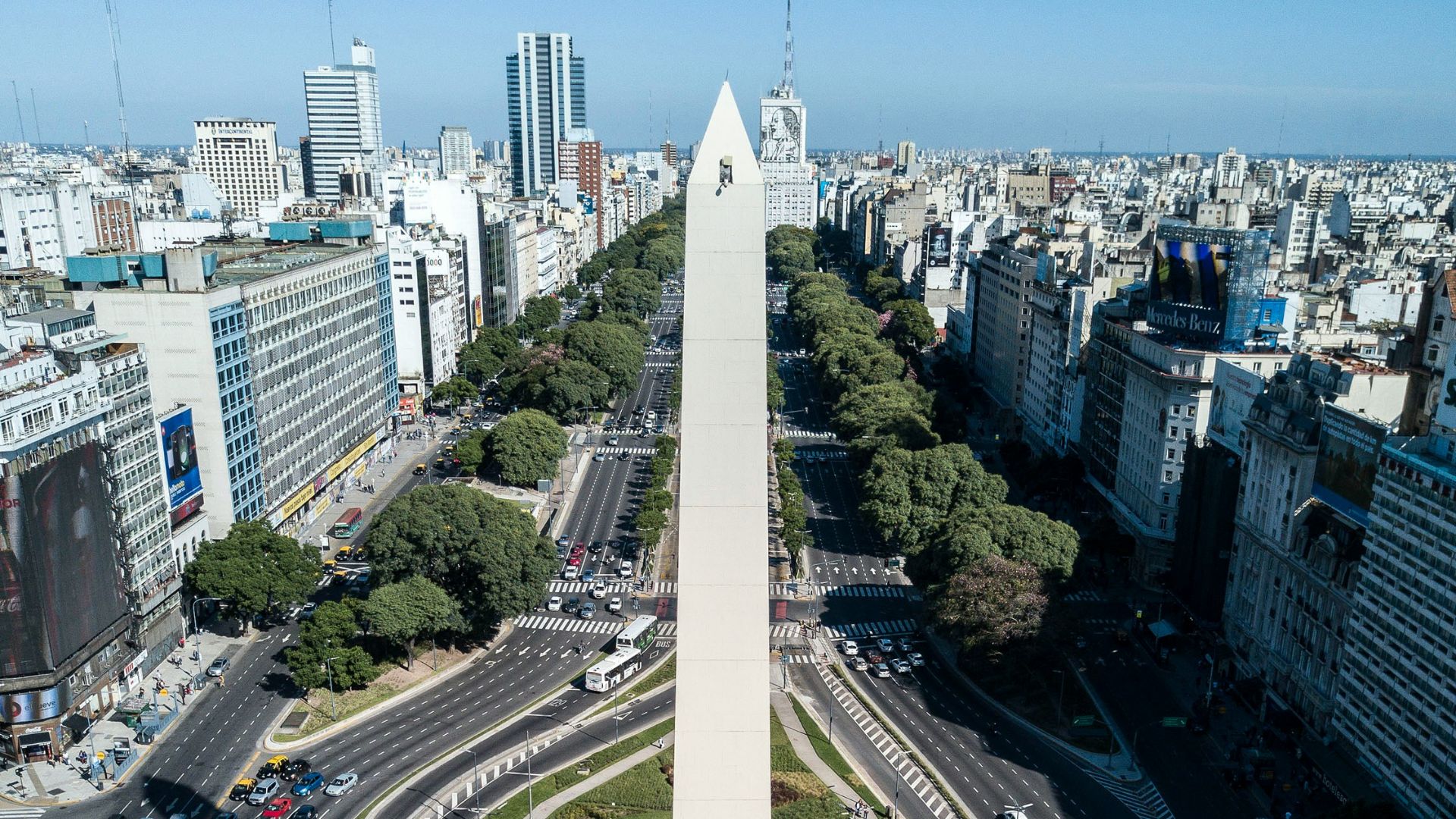cars on road near city buildings during daytime