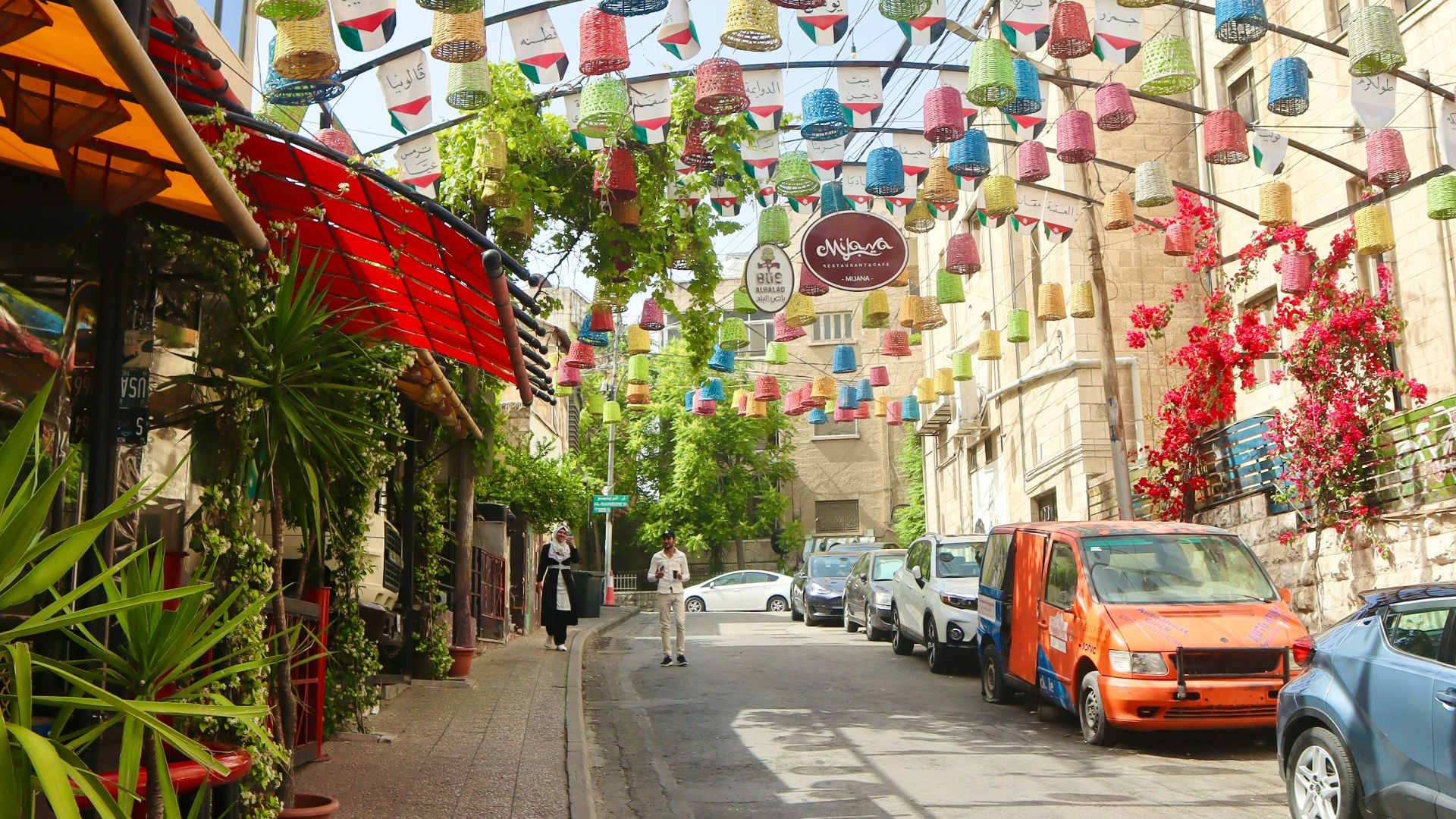 a city street lined with lots of colorful paper lanterns