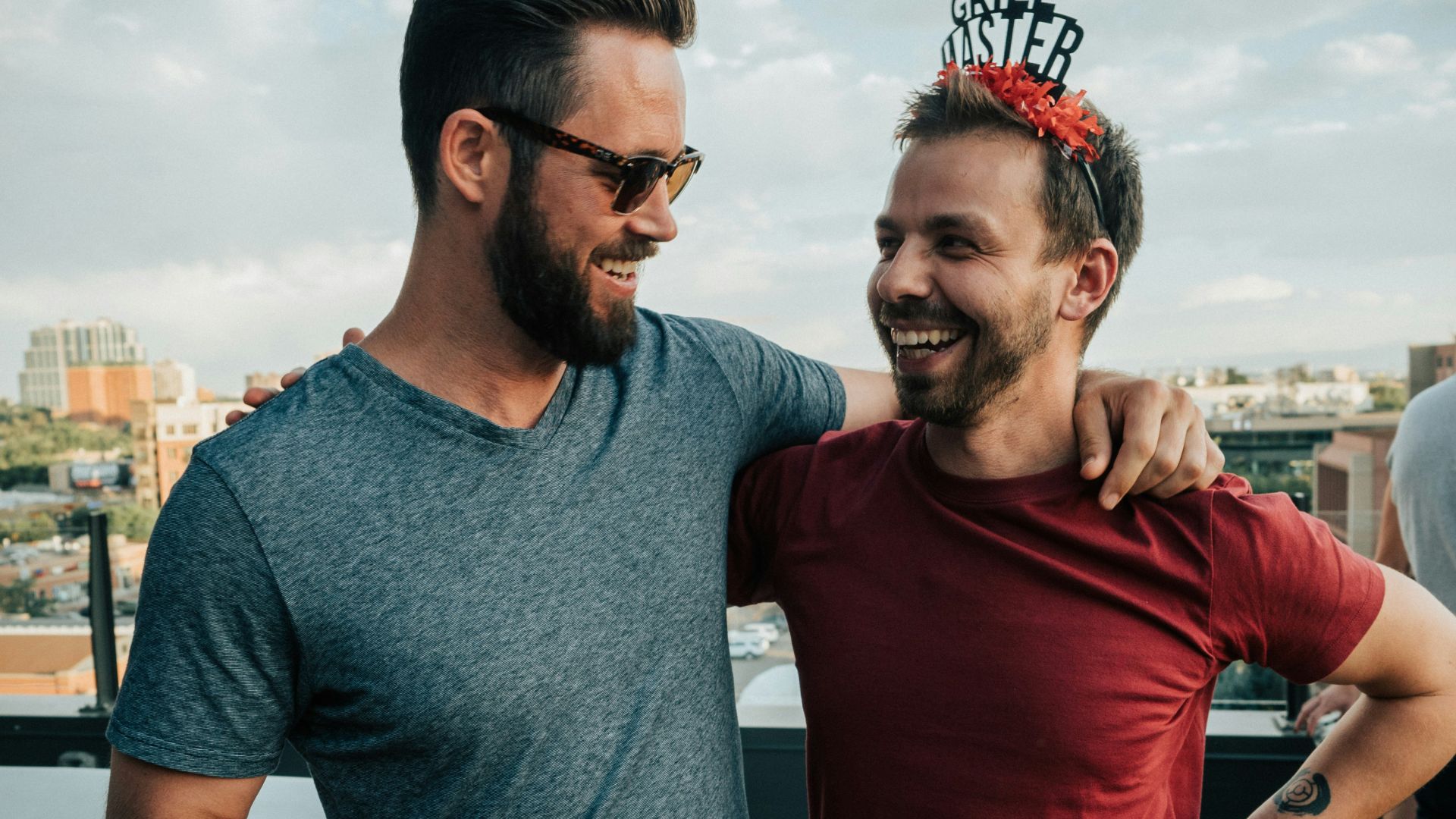 man in gray crew neck t-shirt standing beside man in red crew neck t-shirt
