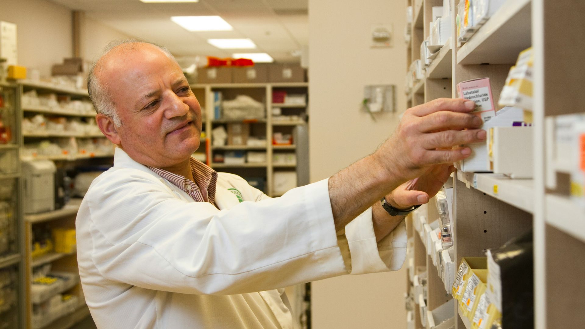 man in white dress shirt holding white paper