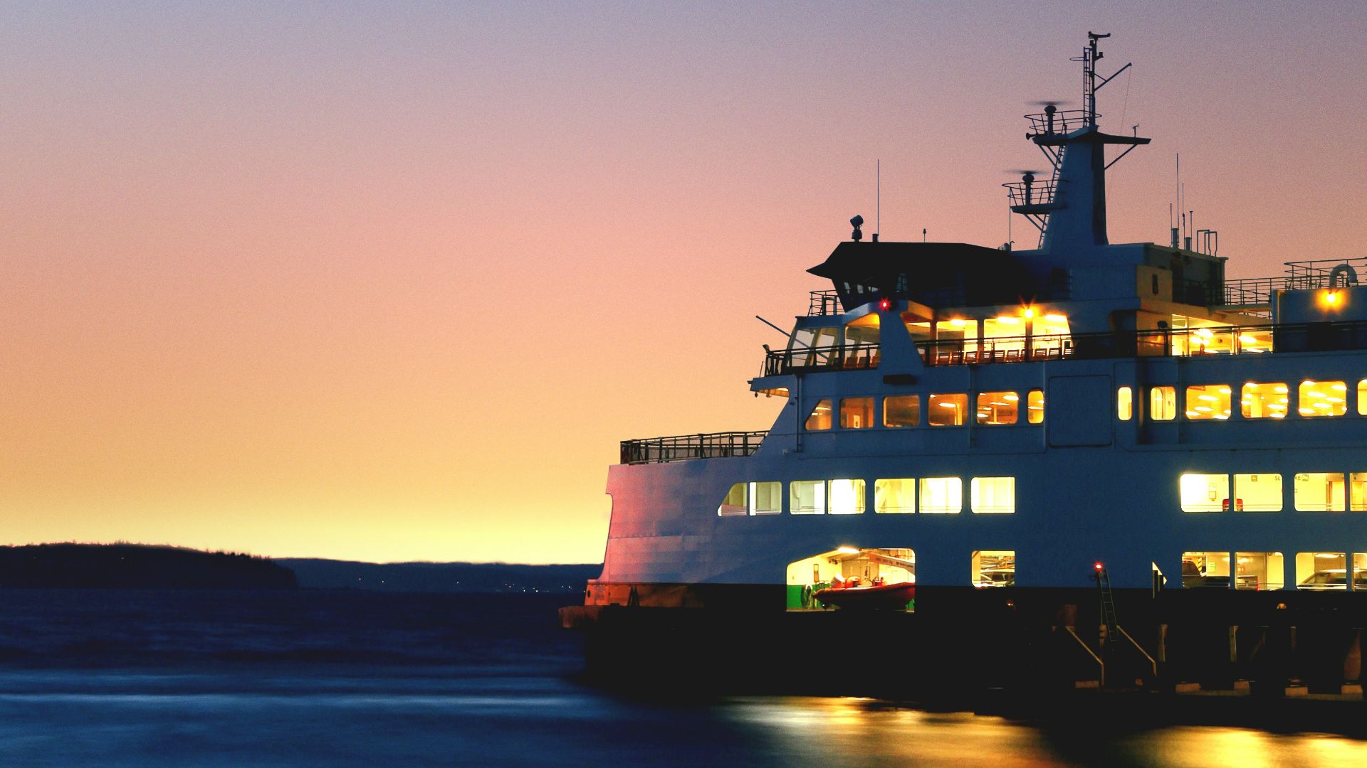 lighted cruiseship on sea taken during golden hour