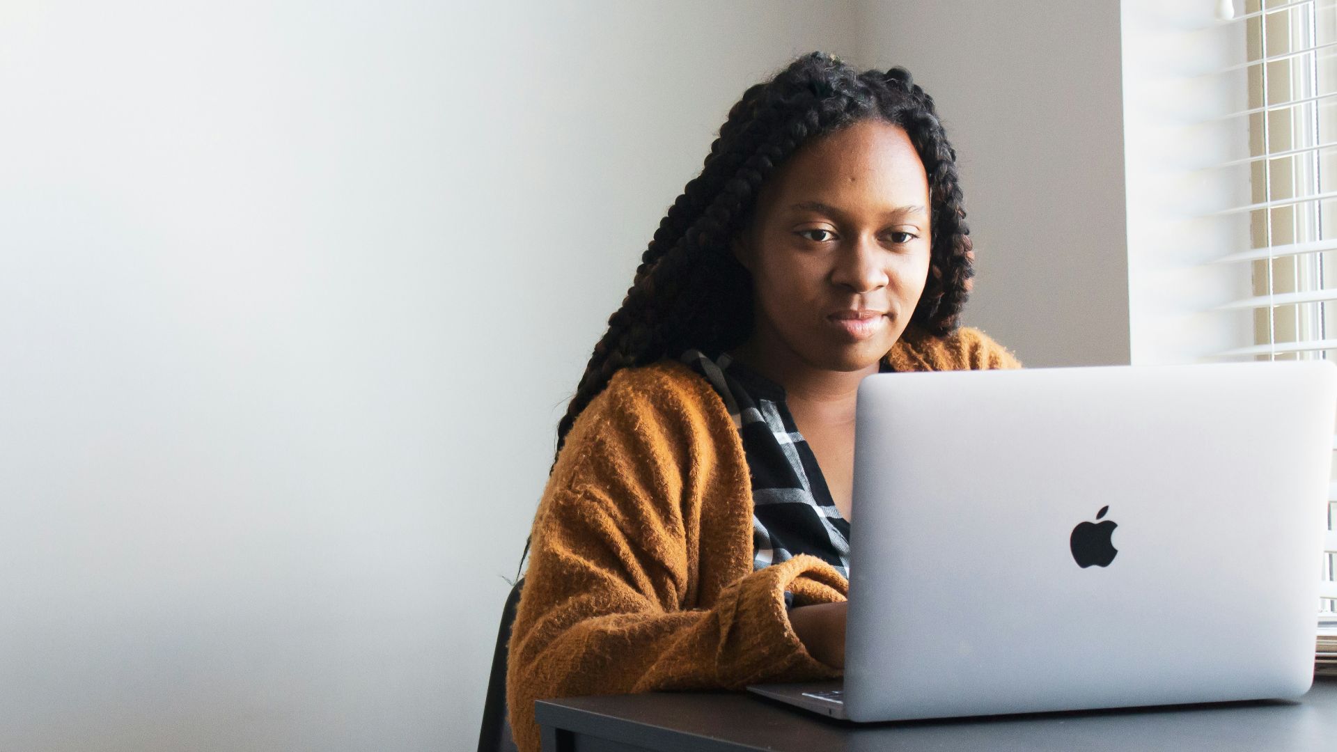 woman in brown and white fur coat sitting on chair