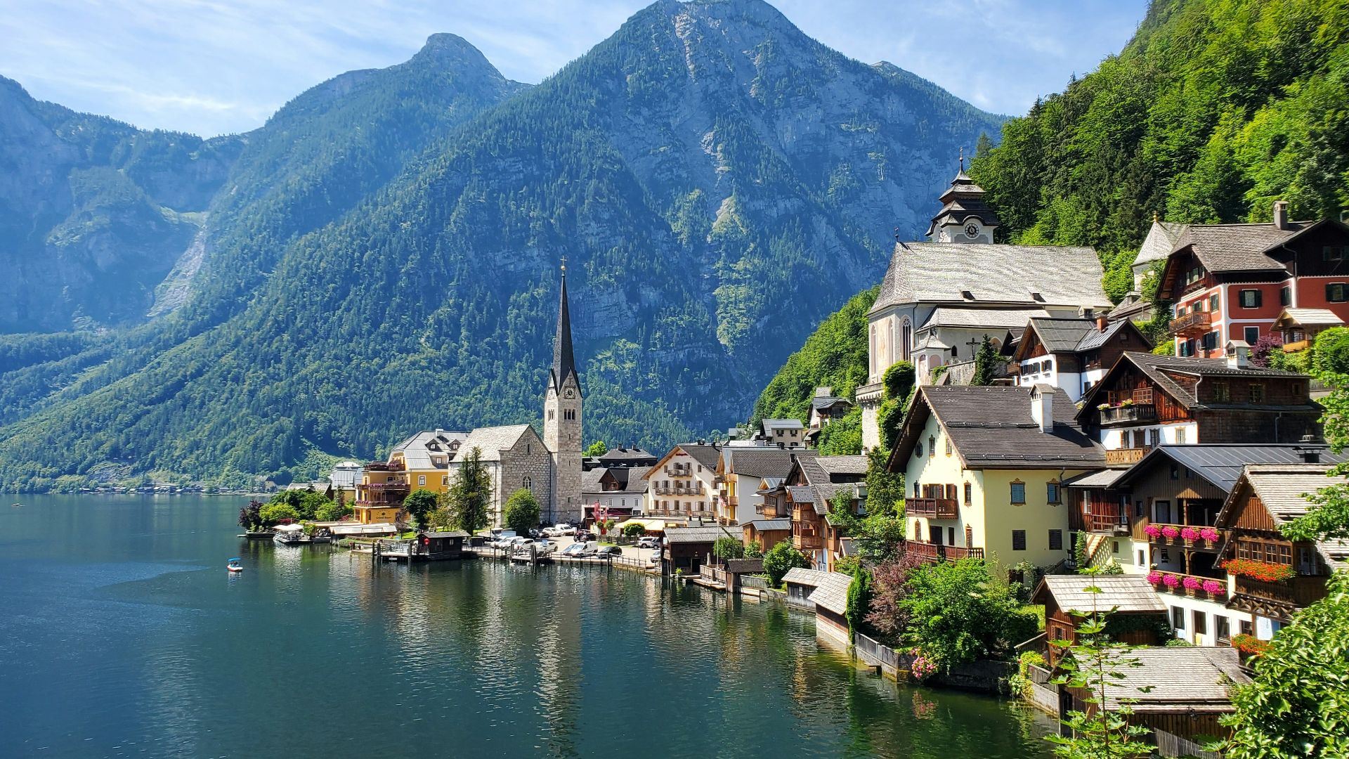 houses near body of water and mountain during daytime