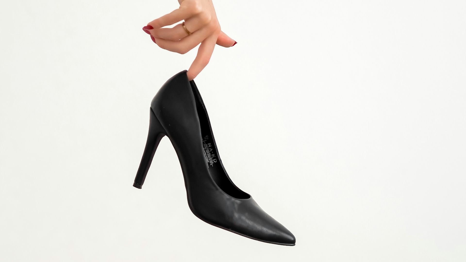 woman in black leather heeled shoes