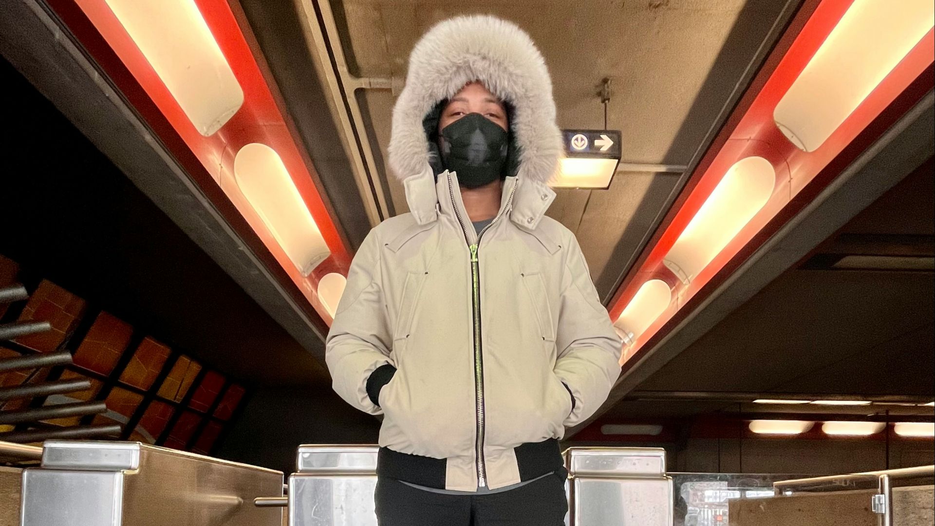 a man wearing a winter coat and a mask