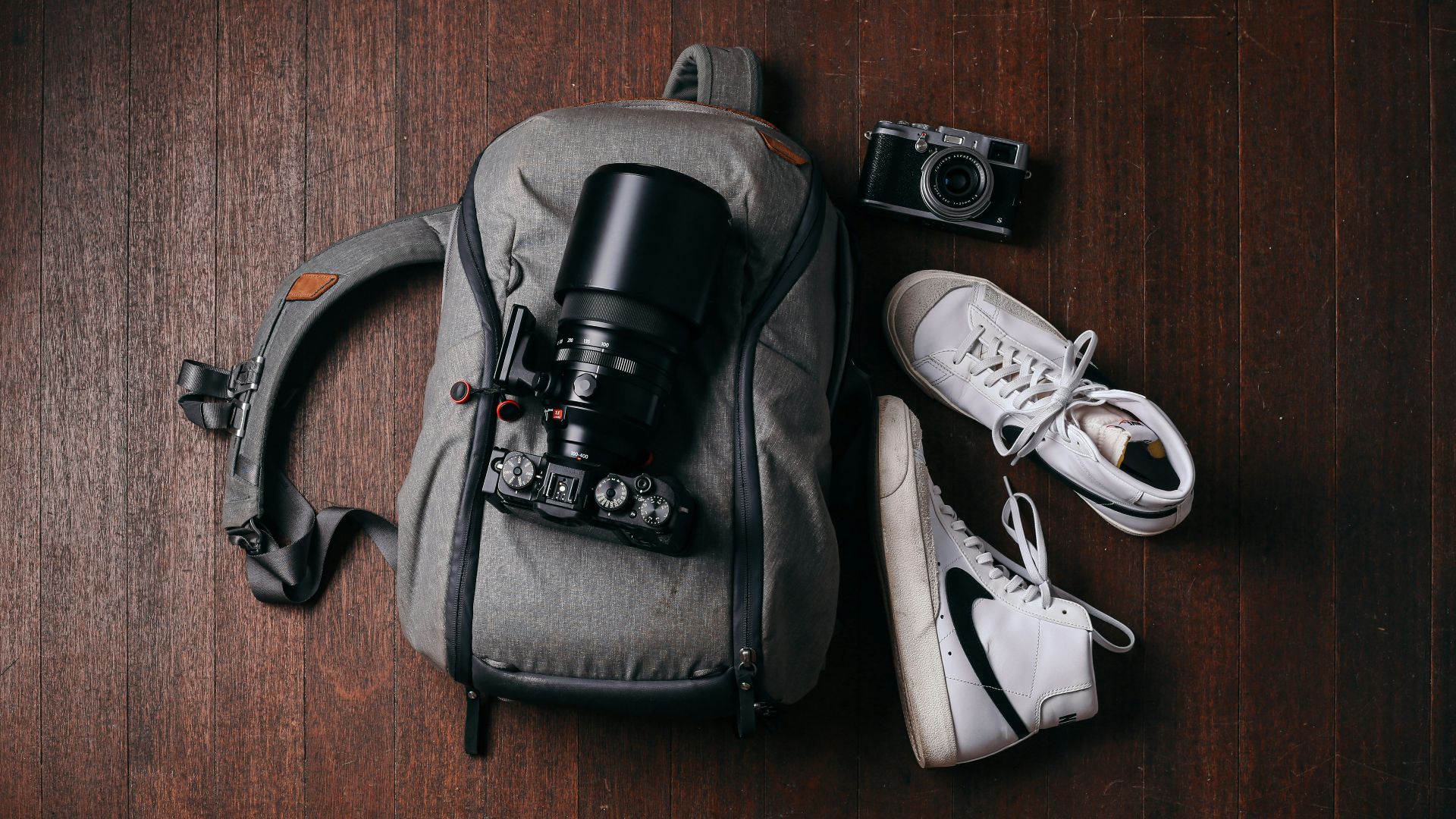 a camera and some shoes on a wooden floor