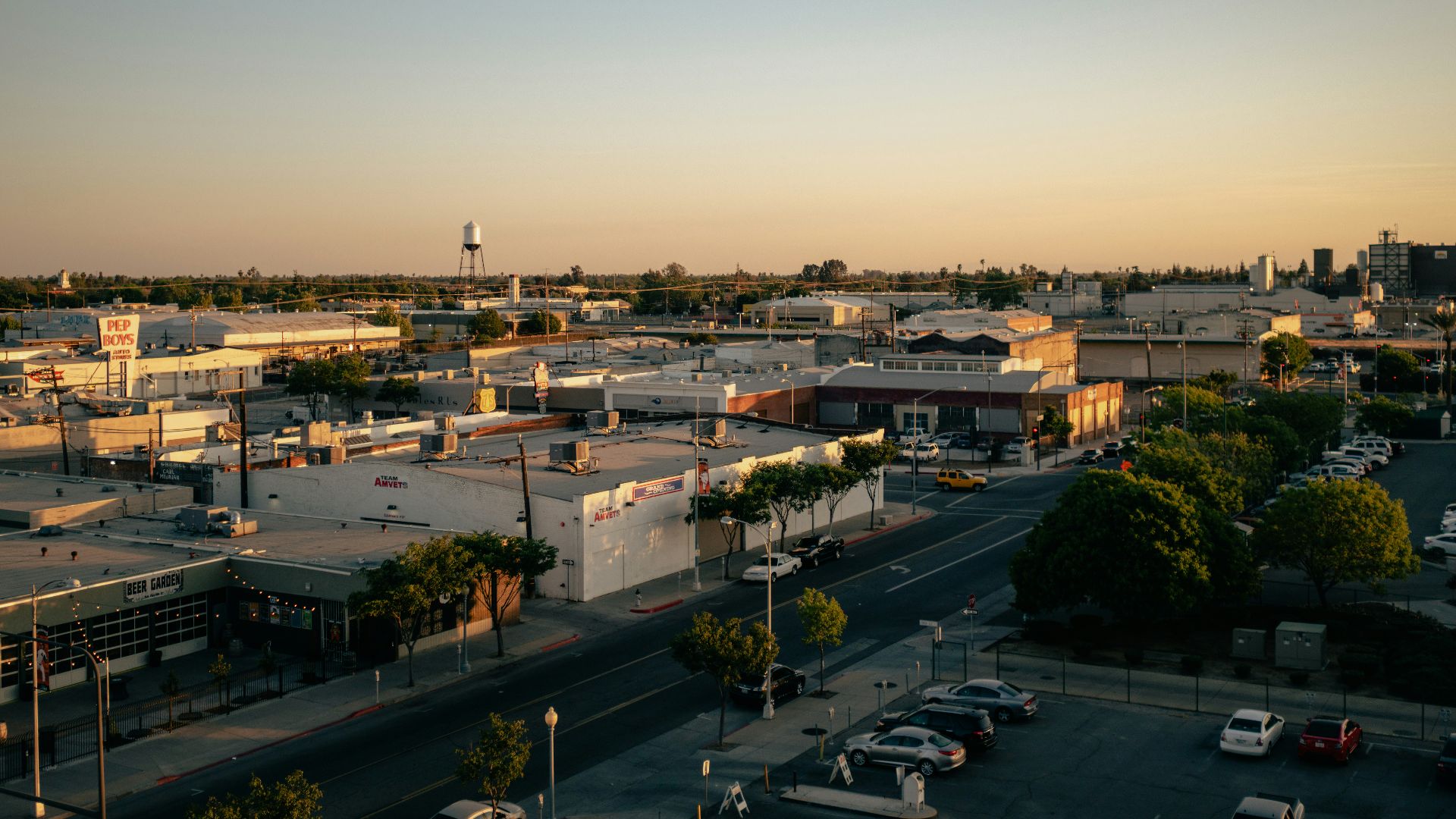 a view of a city street with cars parked on the side of the road