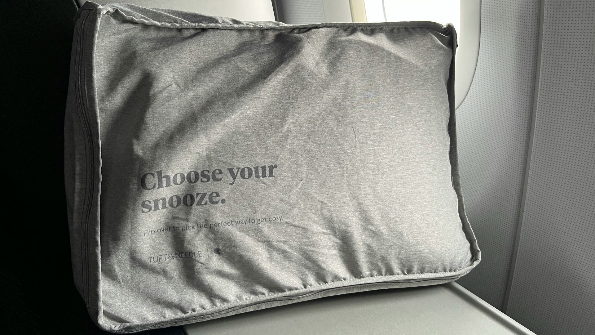 a close up of a pillow on an airplane