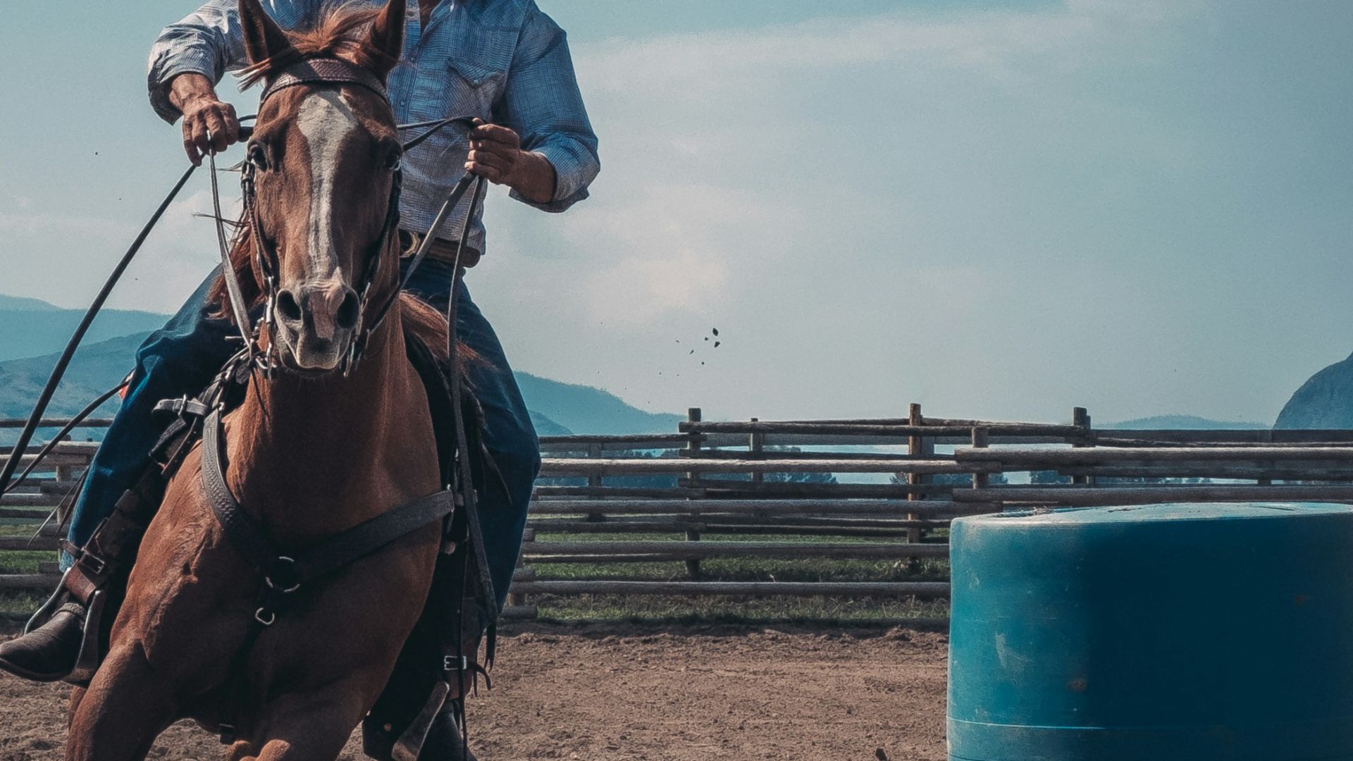 man in white cowboy hat riding a horse