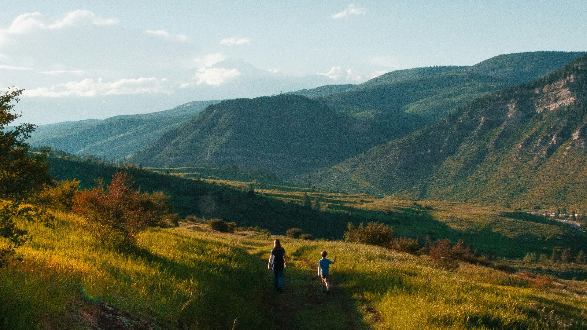 boy and man walking on mountain hill