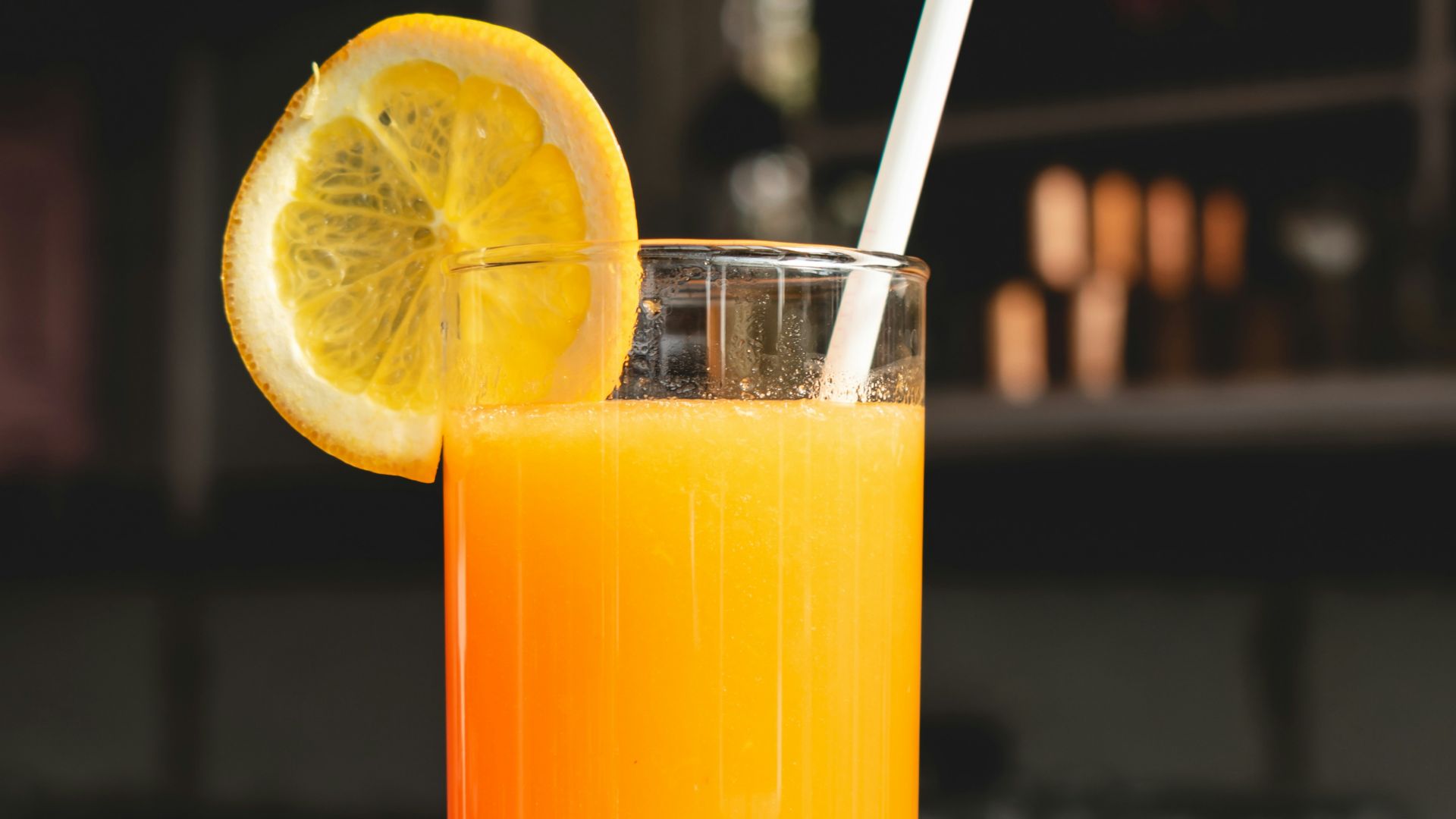 orange juice in clear drinking glass