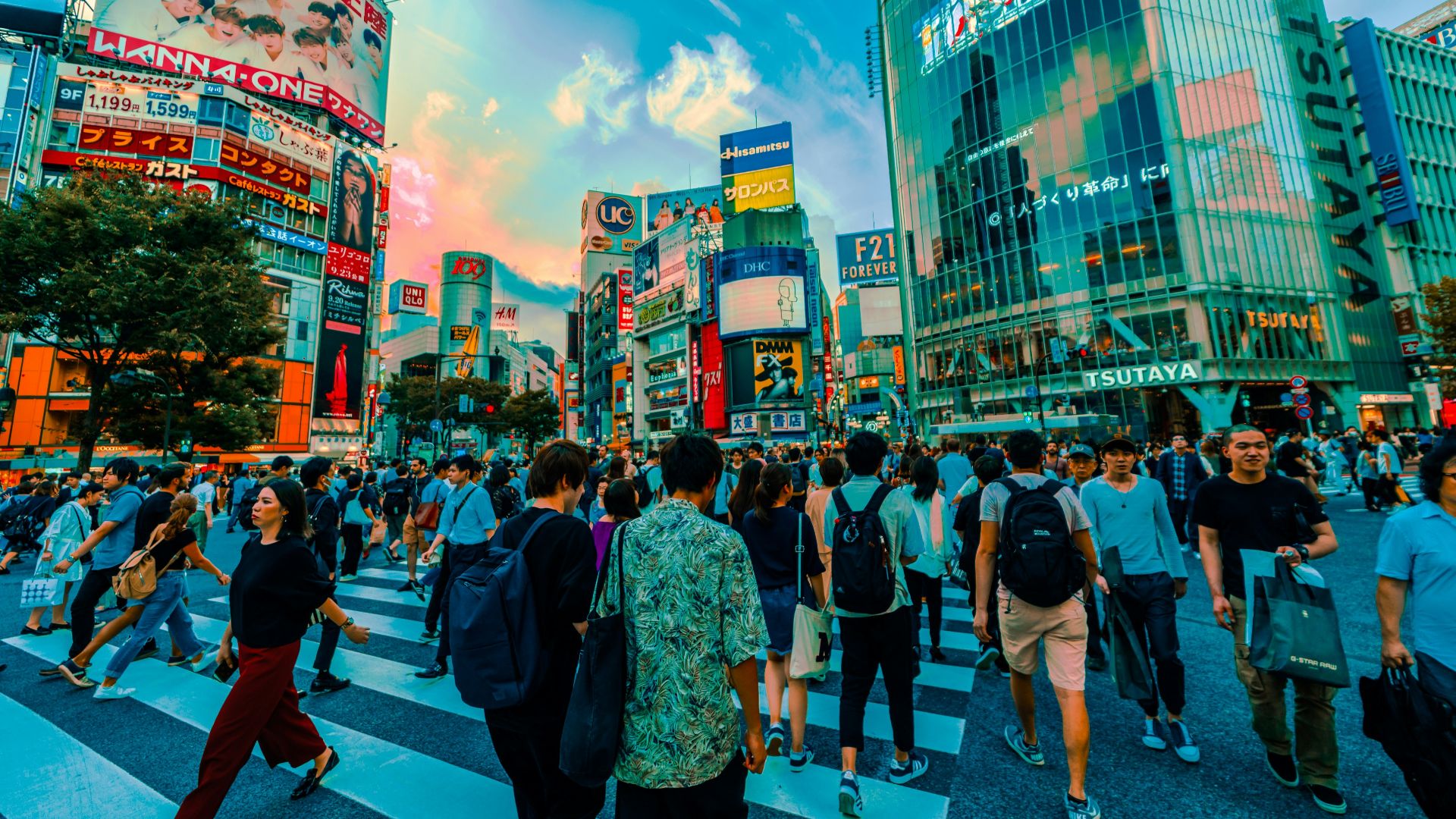 group of people crossing at the pedestrian lane surrounded by buildings