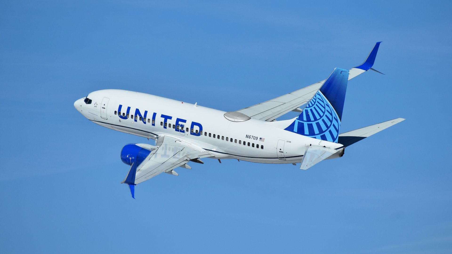 a united airlines plane flying in the sky