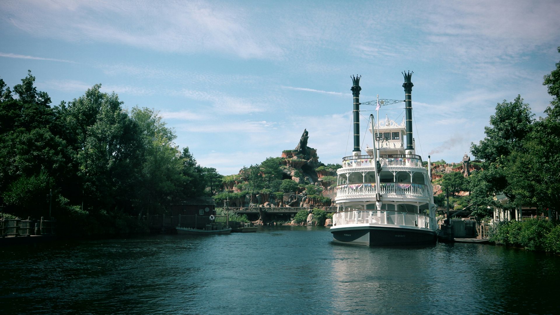 a large white boat floating on top of a river