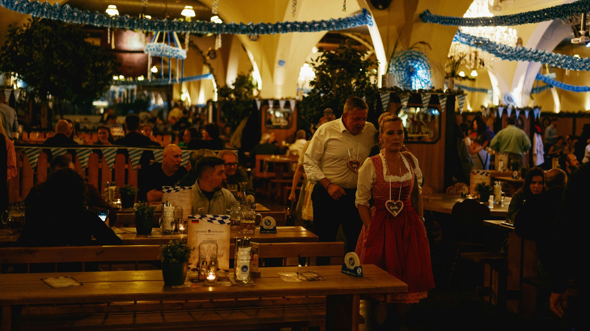 A group of people sitting at tables in a restaurant