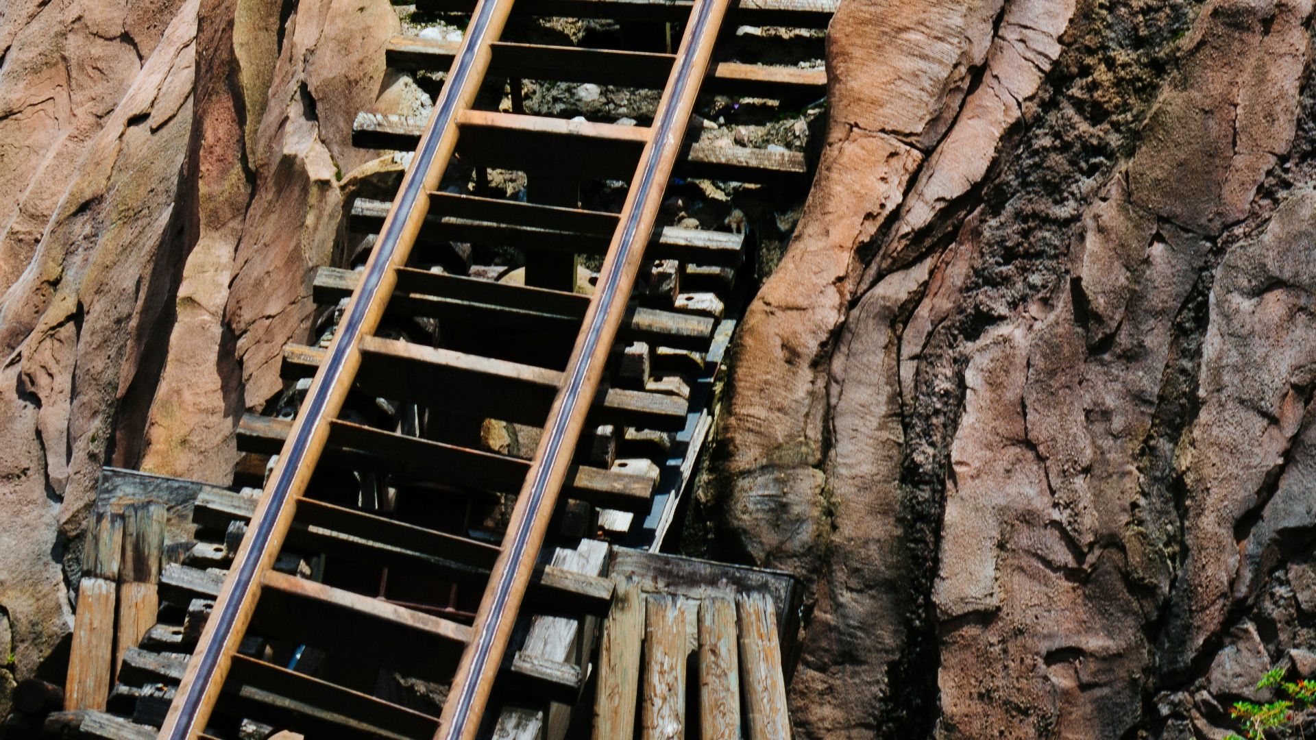 a group of people riding a roller coaster down a mountain