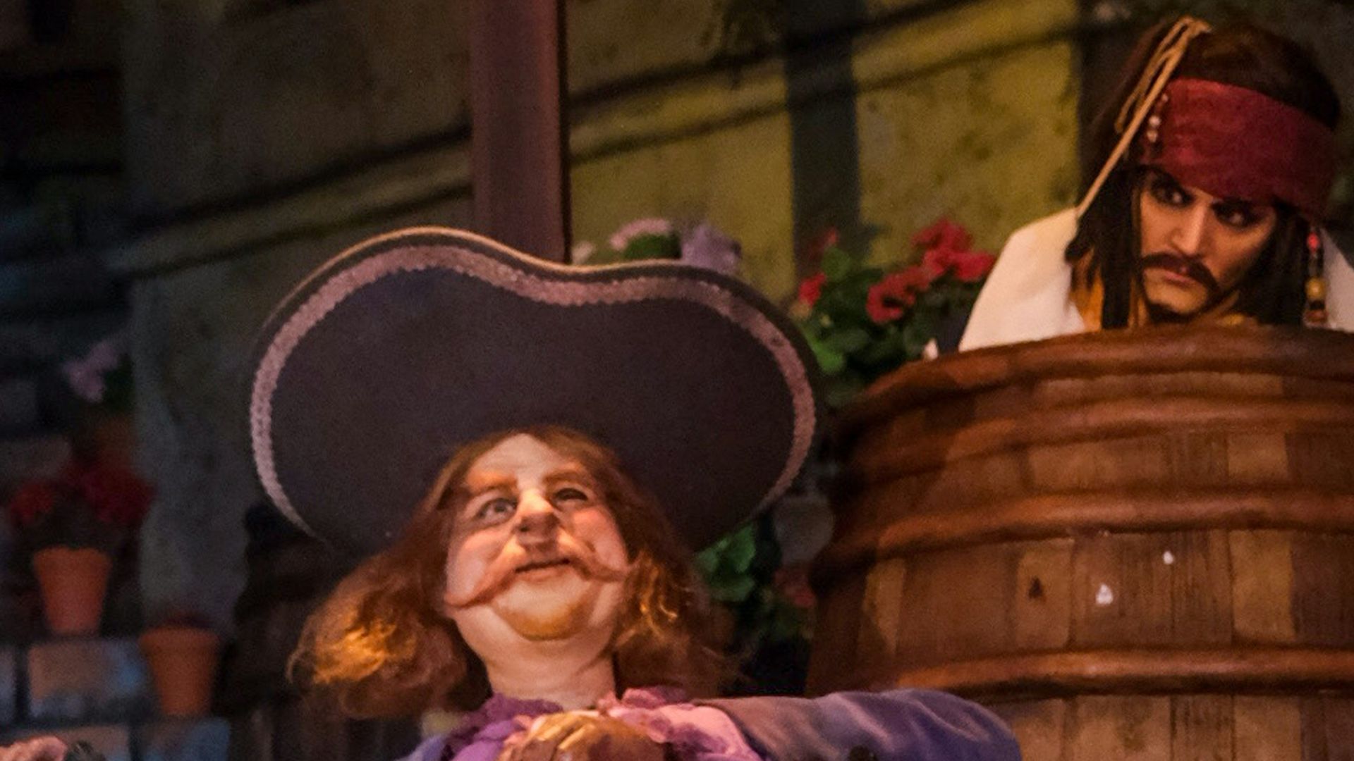 a man in a pirate costume sitting on a barrel