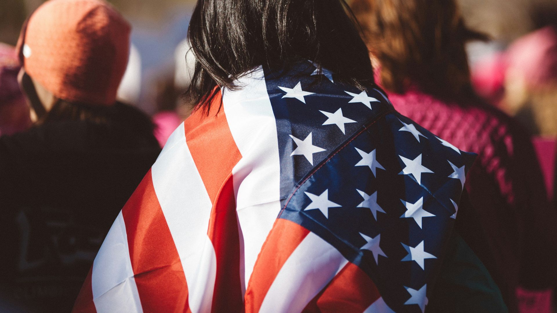 woman with US American flag on her shoulders