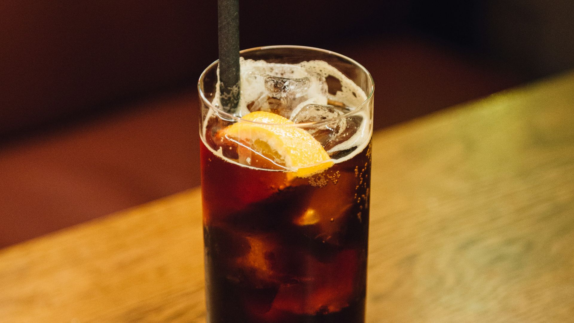 A glass of soda on a wooden table