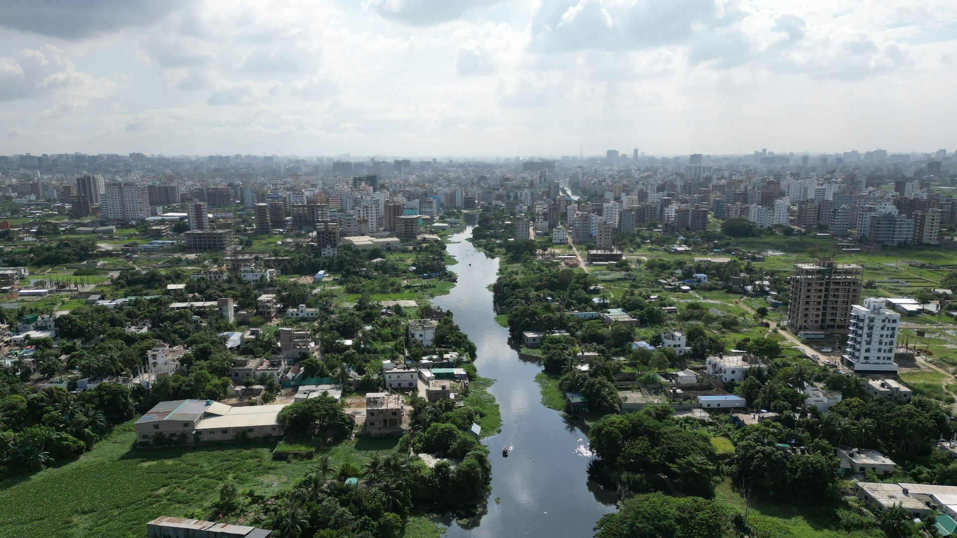 a river running through a lush green countryside