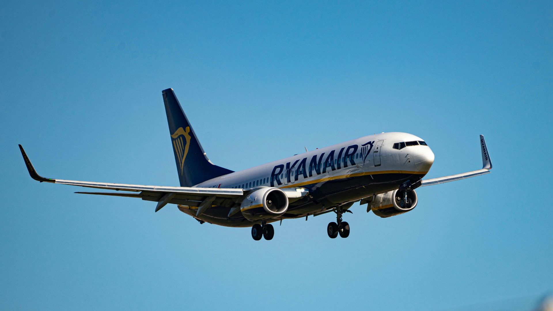 white and blue passenger plane in flight