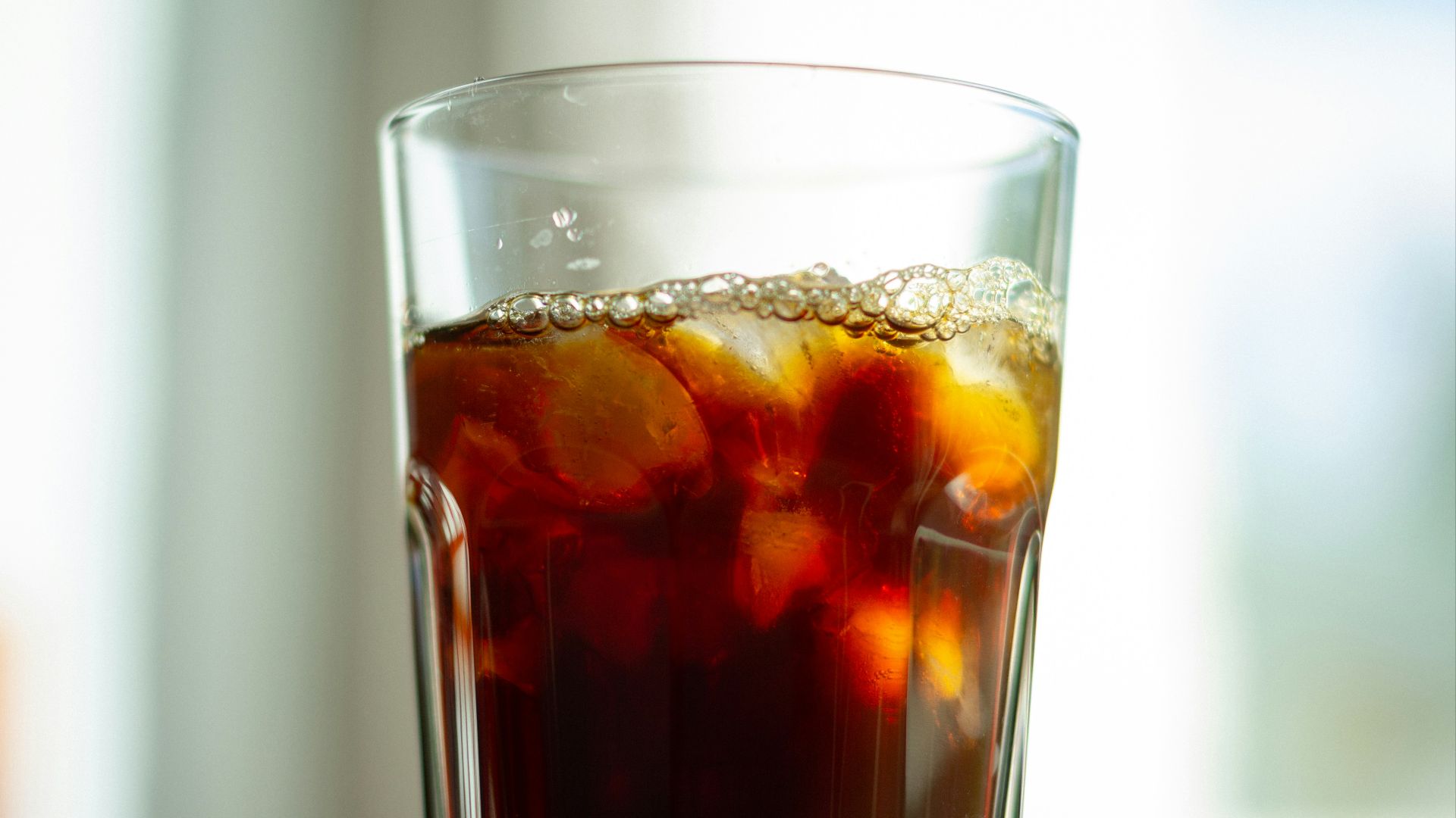 clear drinking glass with brown liquid