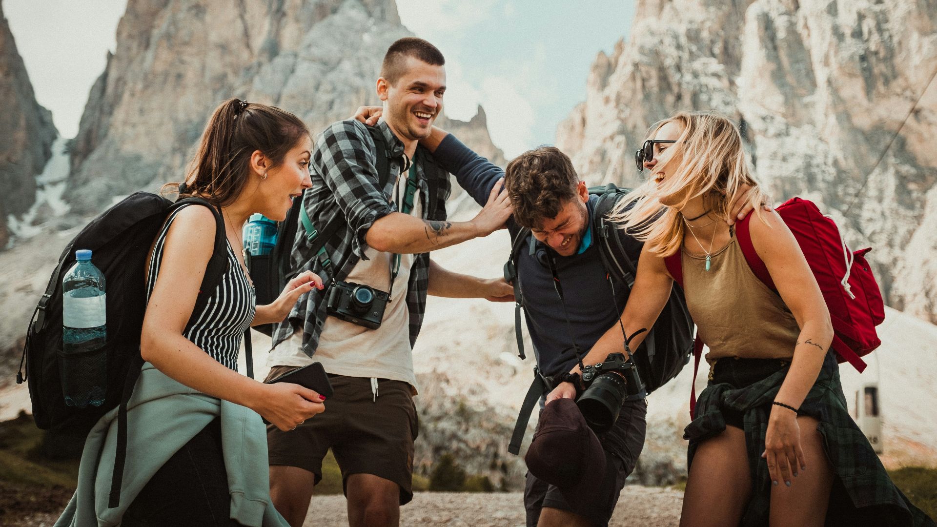 low-angle photography of two men playing beside two women