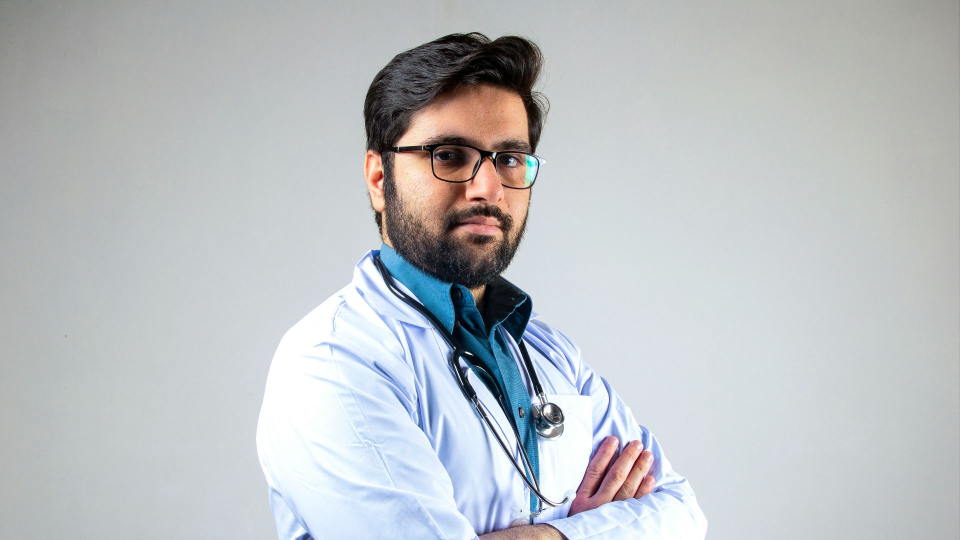 man in white dress shirt wearing black framed eyeglasses