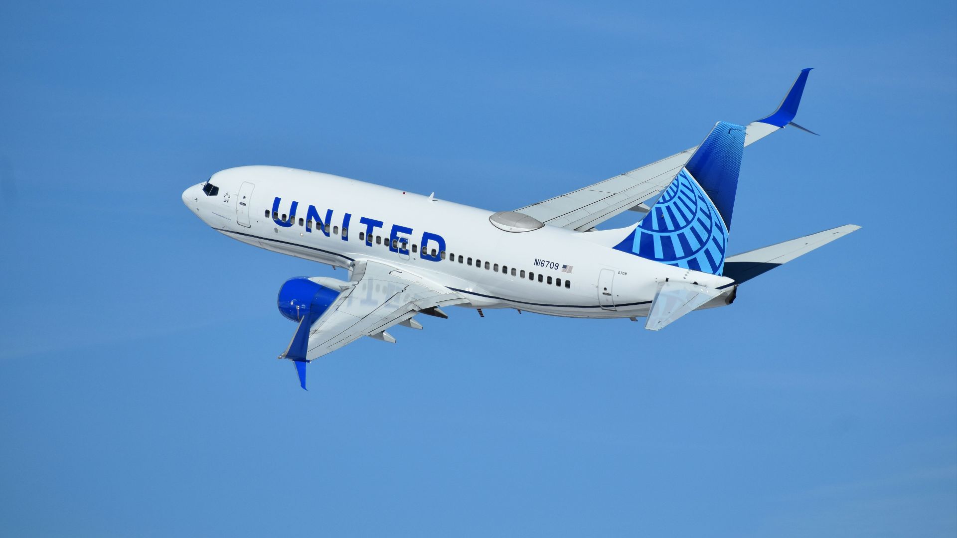 a united airlines plane flying in the sky