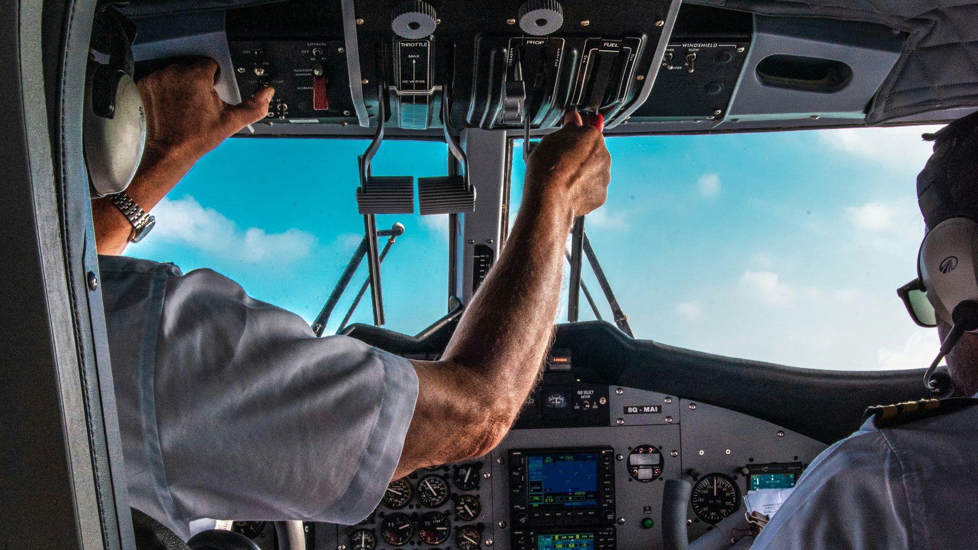 man in blue shirt driving car during daytime