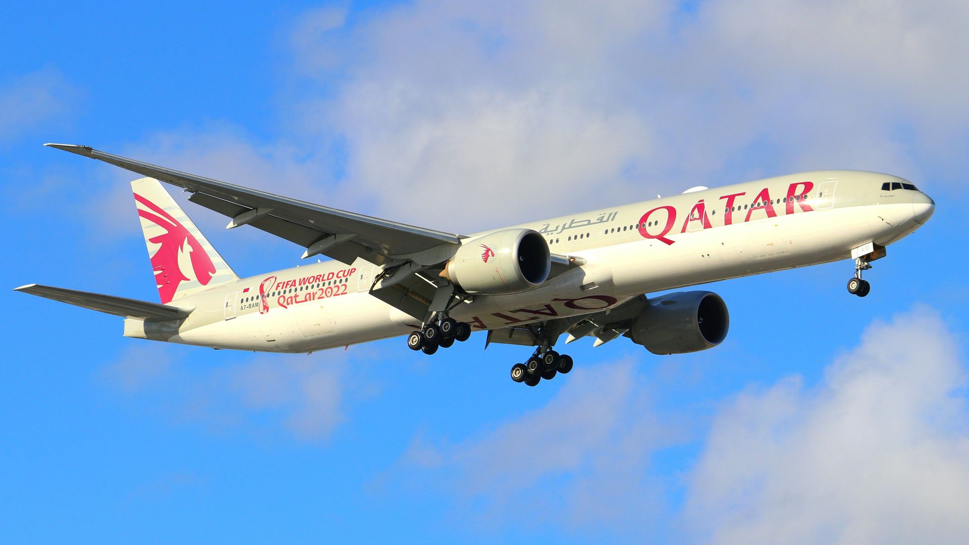 a large jetliner flying through a blue cloudy sky