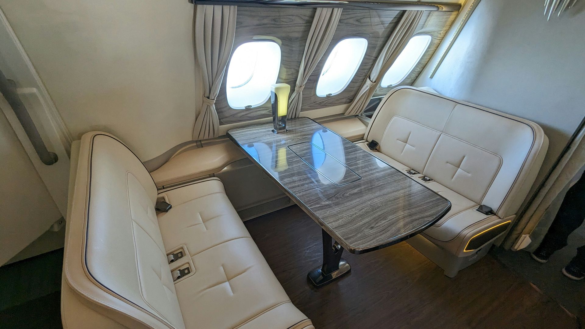 a dining area on an airplane with a table and chairs