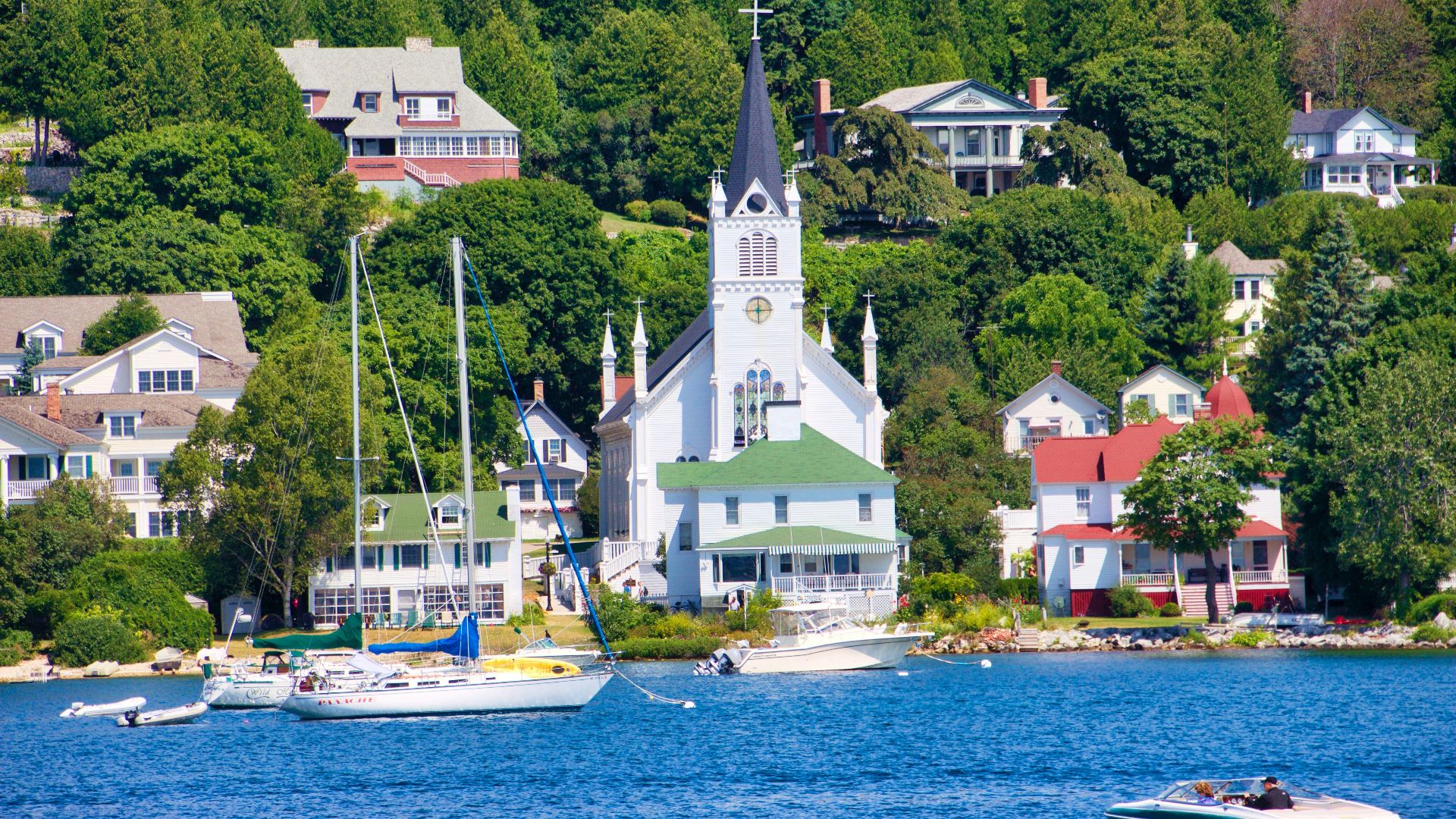 white and brown concrete building near body of water during daytime