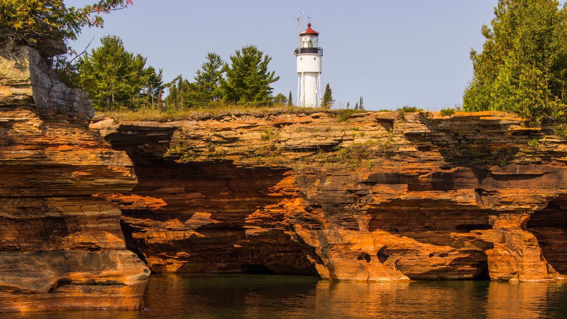 a lighthouse on a cliff above a body of water